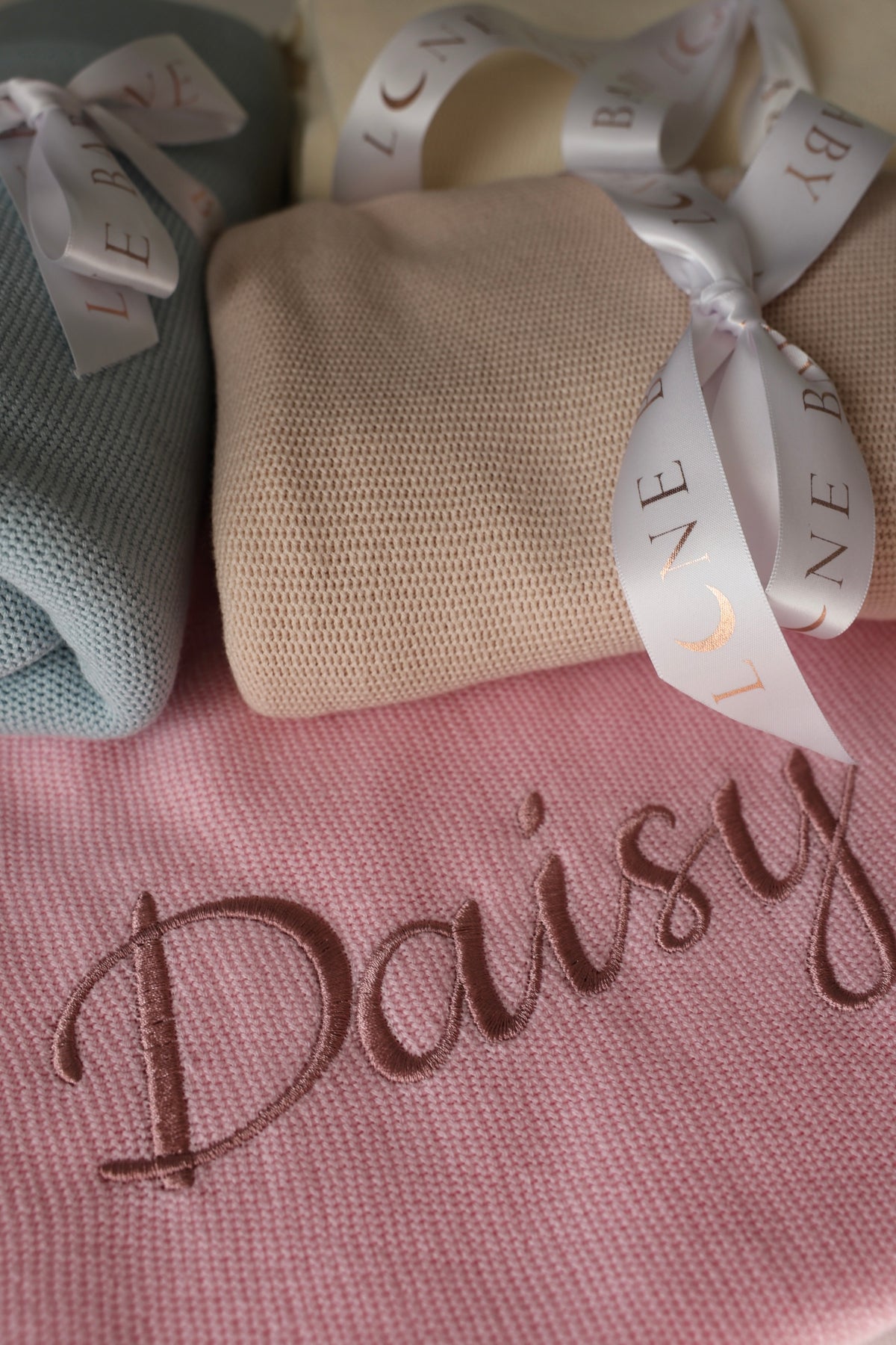 Personalised knitted cotton baby blanket with embroidered name in pink