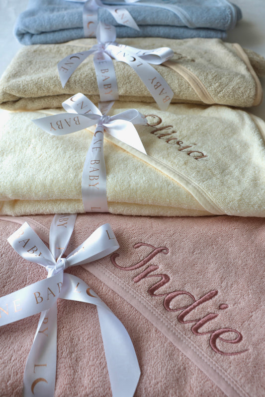 Personalised baby hooded towels in soft organic cotton with embroidered names